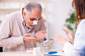 Old man visiting young female doctor for plastic surgery