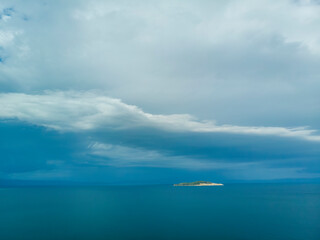 Dark blue sky and sea with island