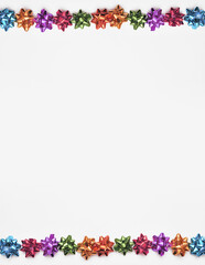 Festive colorful bows on sparkling glitter paper texture. Holiday background. Christmas concept.