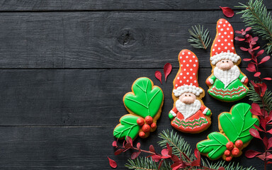 Christmas homemade gingerbread cookies gnomes on black wooden table, copyspace. New year, christmas concept