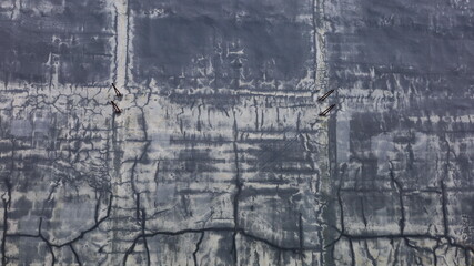 Fototapeta premium Old cement walls that are cracked and dirty. Black cement wall texture or background for background work with copy space. Selective focus