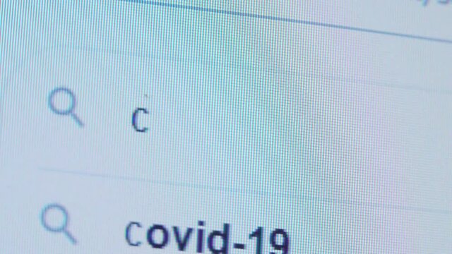The CORONAVIRUS is written in the search bar using the cursor and the magnifying glass symbol. Macro photography of the monitor display.