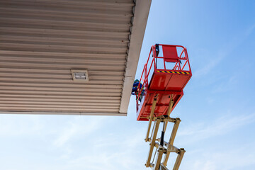 Worker on a Scissor Lift Platform working at site