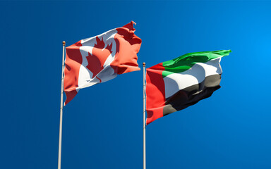 Beautiful national state flags of UAE United Arab Emirates and Canada together at the sky background. 3D artwork concept.