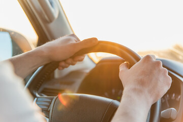 A man driving a car on a Sunny day