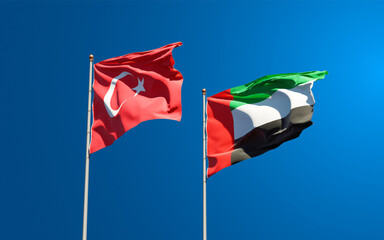 Beautiful national state flags of Turkey and UAE United Arab Emirates together at the sky background. 3D artwork concept.