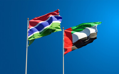 Beautiful national state flags of Gambia and UAE United Arab Emirates together at the sky background. 3D artwork concept.