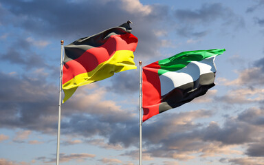 Beautiful national state flags of Germany and UAE United Arab Emirates together at the sky background. 3D artwork concept.