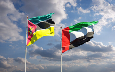 Beautiful national state flags of Mozambique and UAE United Arab Emirates together at the sky background. 3D artwork concept.