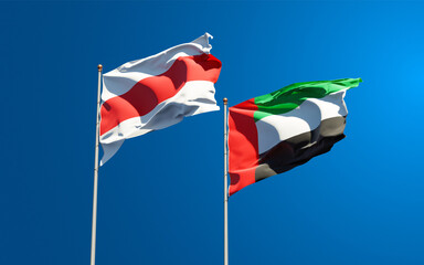 Beautiful national state flags of New Belarus and UAE United Arab Emirates together at the sky background. 3D artwork concept.