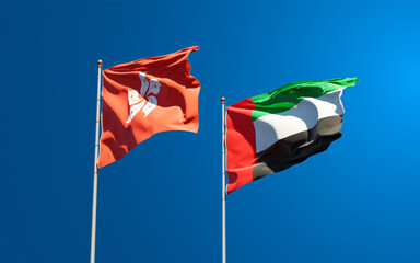 Beautiful national state flags of Hong Kong HK and UAE United Arab Emirates together at the sky background. 3D artwork concept.