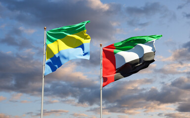 Beautiful national state flags of Gabon and UAE United Arab Emirates together at the sky background. 3D artwork concept.