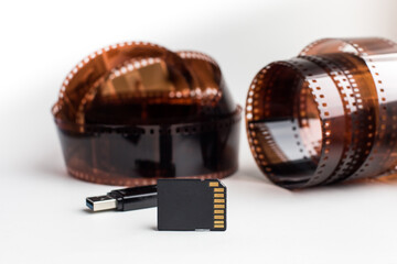 modern sd and usb flash card on vintage 35mm film background, concept of saving information at different times