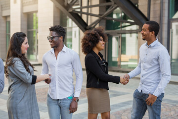 team of young people shaking hands