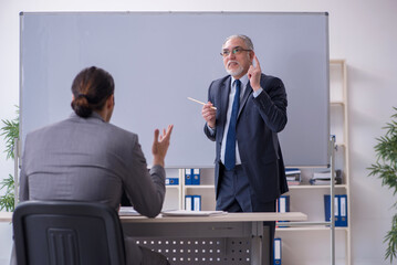 Old and young businessmen in business meeting concept