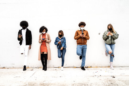 Multiracial Group Of Friends With Masks Keeping Distance Outdoor.