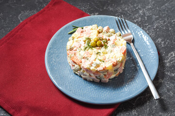 Russian traditional salad Olivier with vegetables and meat.