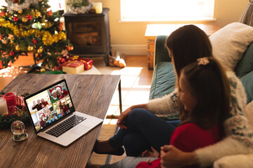 Caucasian woman with her daughter at christmas on a video call