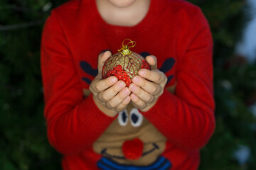 Christmas ball decoration in child hands