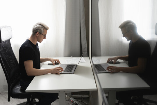 A man works at home using a laptop. Remote work concept during a pandemic