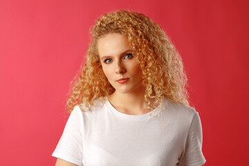 Fototapeta premium Gorgeous beautiful young woman with curly hair posing at camera