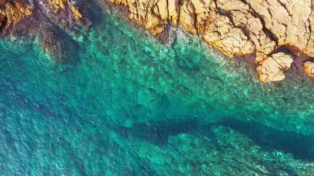 Aerial top down view of blue clear sea water surface