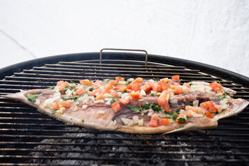 Grilled grilled fish with vinaigrette on top