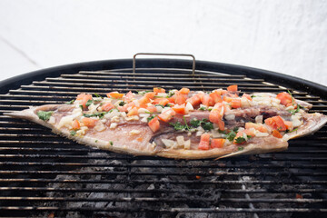 Grilled grilled fish with vinaigrette on top