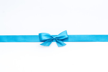Blue ribbon with bow isolated on white for gift box. Top view, copy space