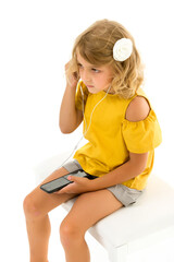 Cute little kid wearing headphones listening to music. Kid listening to music. Music recommended...