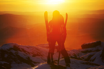 Skier against the backdrop of the sunset on top of the mountain. Resort Sheregesh. Russia