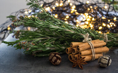 Cinnamon sticks, star anise and rosemary on a table. 