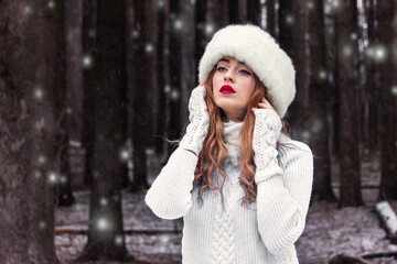 Beautiful girl in a white fur hat in the forest. Fabulous photo. Russian. In the role of Anna Karenina. New Year's, snowy photo session.