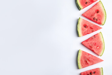 Slices of ripe watermelon on white background, flat lay. Space for text
