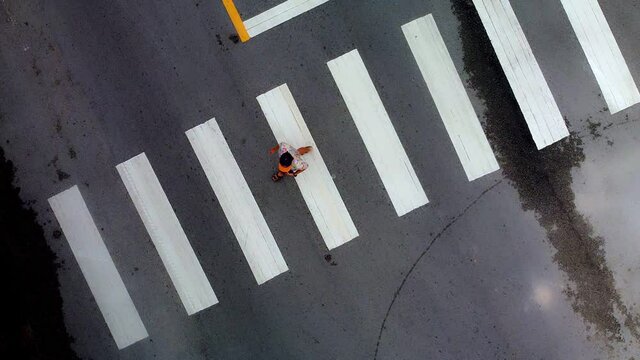 aerial view of abstract crosswalk on asphalt road. person crossing the road. driver not respect traffic rule. low Traffic discipline concept.