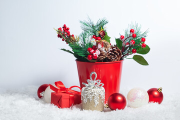 Christmas card composition with snow and Christmas tree branches decoration and present boxes on the white background
