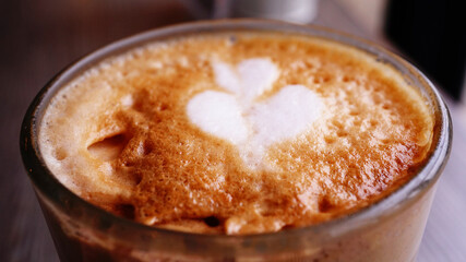 Close up high angle view coffee latte art in the glass.
