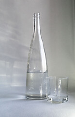 Aesthetically beautiful picture. Crystal clear water plays in the sun. There is a glass next to it. The workplace for drawing. 
