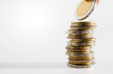 row of coin stack growing pile on white background for money saving and investment business financial and banking concept.