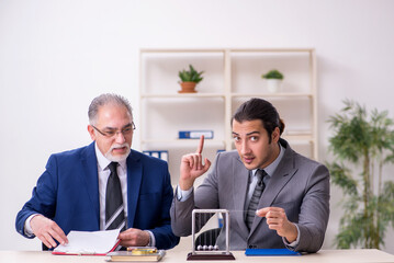 Two businessmen and meditation balls on the table