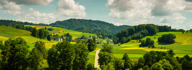 Picturesque view in the beautiful hills. Summer rural view. Colorful summer rural view of farmland. Beautiful outdoor scene near Basel, Switzerland, Europe. Artistic style post processed photo.