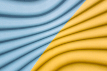 Abstract background from yellow and blue color with curve shadows on it