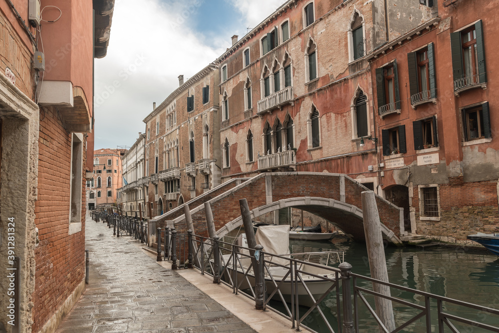 Wall mural alley view with historical buildings in venice, italy.