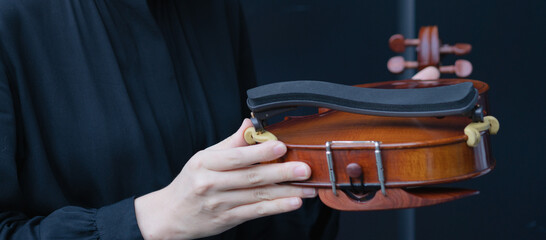 woman holding violin shoulder rest