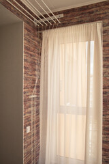 Fototapeta premium A ceiling linen drayer hanger in the interior of the room