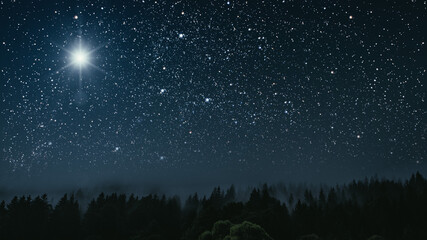 The star shines over the manger of christmas of Jesus Christ.