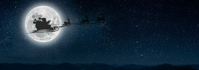 silhouette of a flying goth santa claus against the background of the night sky. Elements of this...