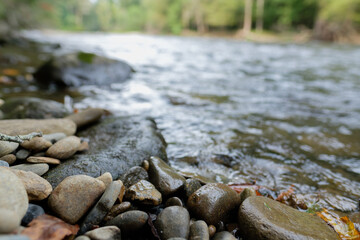 Low angle of Oconaluftee river running along side a hiking path in Smoky mountains national park 
