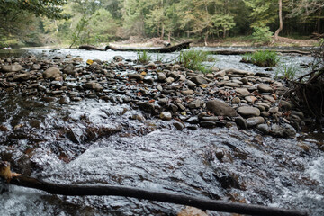 Low angle of Oconaluftee river running along side a hiking path in Smoky mountains national park 