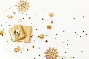 christmas or new year frame composition. christmas decorations in gold colors on white background with empty copy space for text.